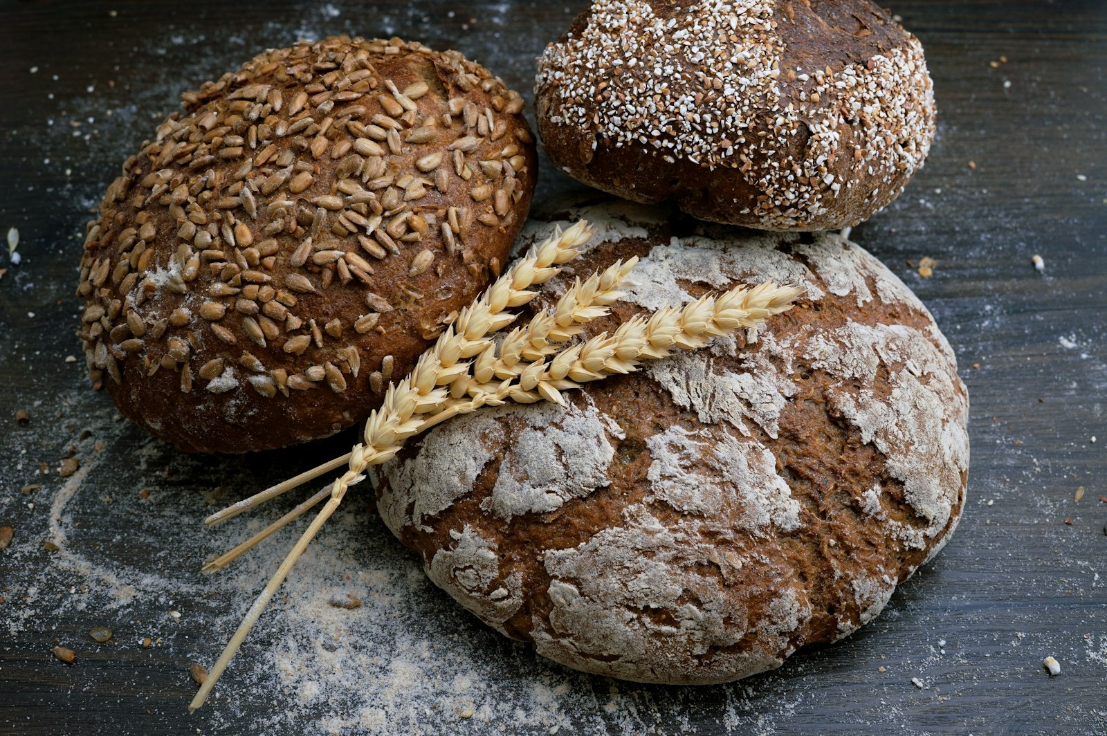Rustic seeded loaves of freshly baked bread dusted with flour (placeholder photo)